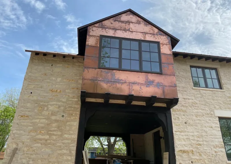 Copper metal panel facade on a stone building for Skylight Installation in Belpre